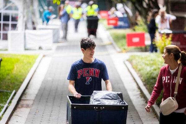 penn student pushing a move-in cart