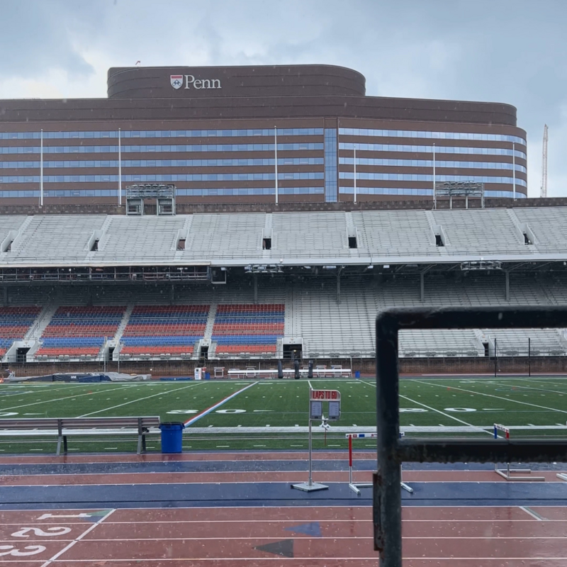 A view of Franklin Field from the stands during a rain storm with the Hospital of the 澳门娱乐城网上赌场 in the background